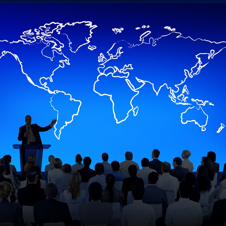 A speaker presenting at a conference