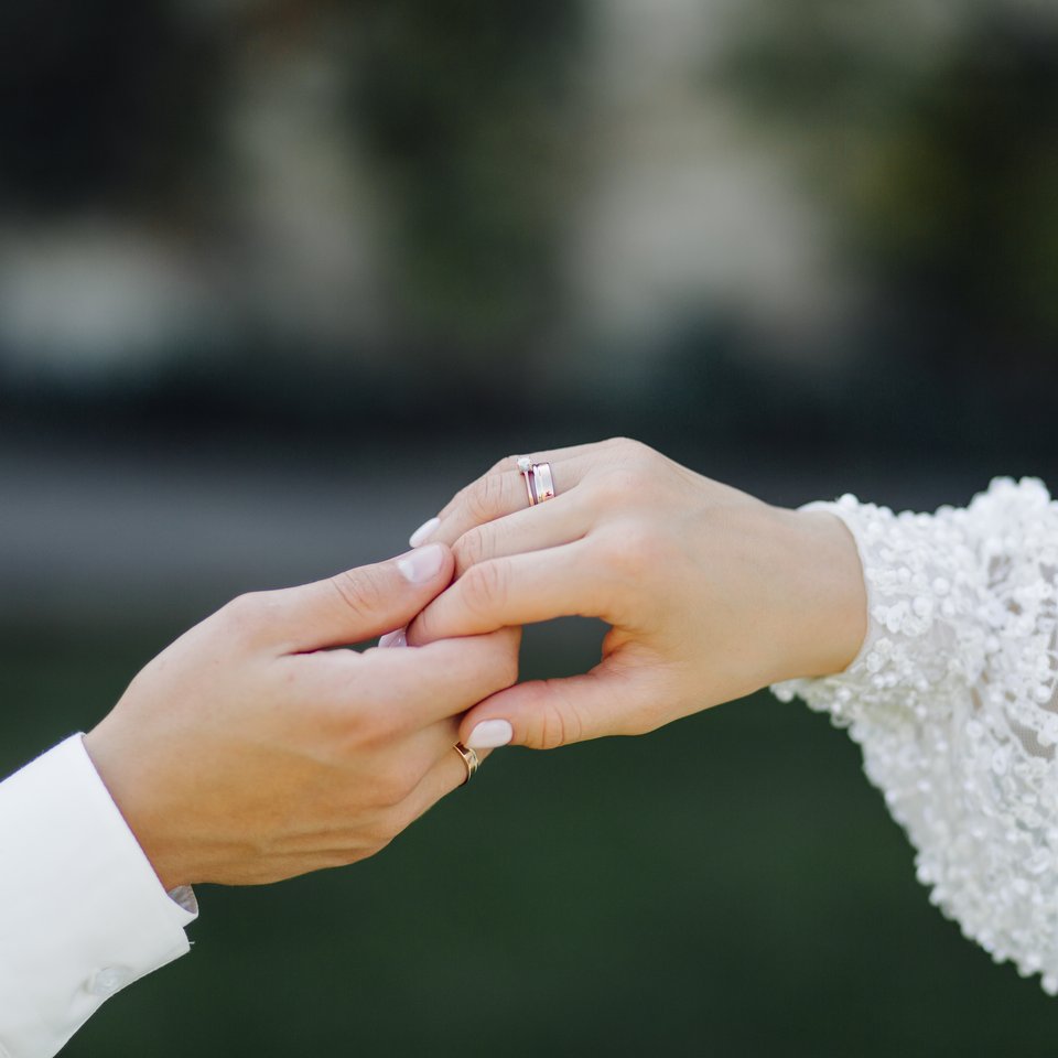 A couple holding hands at their wedding